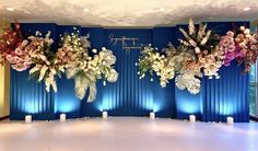 a room with blue walls decorated with flowers and candles