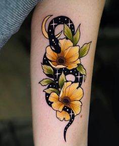 a sunflower tattoo on the arm with an arrow and stars around it's center