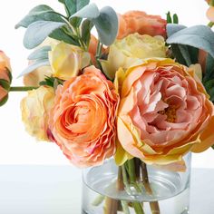 an arrangement of flowers in a glass vase