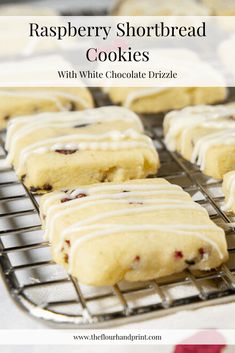 raspberry shortbread cookies with white chocolate drizzle on a cooling rack