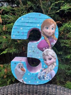 the letter e is decorated with frozen princess characters