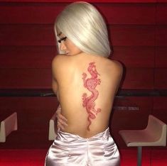 a woman with a dragon tattoo on her back