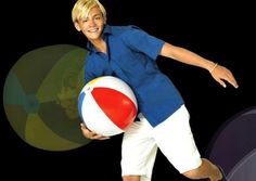 a woman holding a beach ball in her right hand and smiling at the camera, on a black background