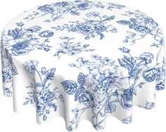 a blue and white floral tablecloth with flowers on the top, in front of a white background