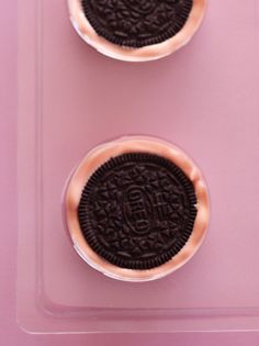 two oreo cookies sitting on top of each other