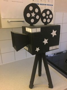 a black and white film projector sitting on top of a counter next to a stove