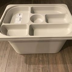 a white plastic container with four compartments