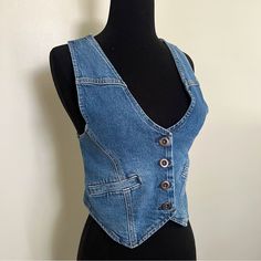 You'll Feel On-Trend Wearing This Women's Denim Vest By A.N.A As A Layering Piece. Crafted From A Structured Recycled Denim Blend With A Hint Of Stretch, This Sleeveless Cropped Vest Has A Button-Front Closure And Side Slip Pockets. Wear It On Its Own With Wide-Leg Pants Or Jeans Or Over A Fitted Baby Tee. Strap Type: Adjustable Closure Type: Button Fit: Regular Fit Neckline: V Neck Pockets: 2 Front Slip Pockets Sleeve Length: Sleeveless Apparel Length: 20 Inches - Front Fiber Content: 94% Cotto Fitted Blue Cotton Denim Vest, Fitted Denim Jacket In Recycled Denim, Fitted Medium Wash Recycled Denim Jacket, Fitted Recycled Denim Jacket, Fitted Casual Denim Vest In Medium Wash, Fitted Casual Denim Vest, Trendy Fitted Blue Denim Vest, Fitted Washed Denim Vest, Fitted Washed Blue Denim Jacket