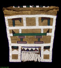 a piece of cloth with different designs on it and fringes hanging from the side