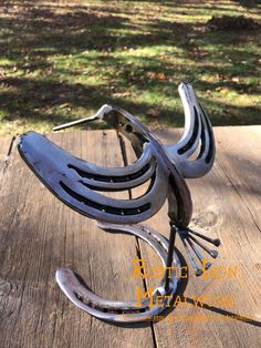 a metal sculpture sitting on top of a wooden table