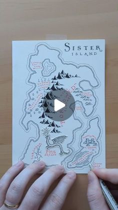 a person holding up a piece of paper with a map on it that says sister island