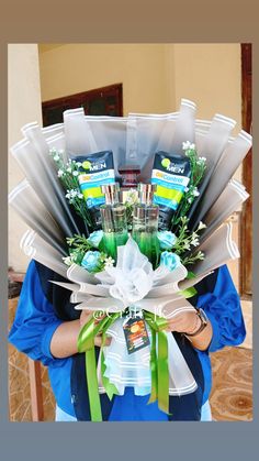 a woman holding a large bouquet of flowers in her hands and some tissues on the other side