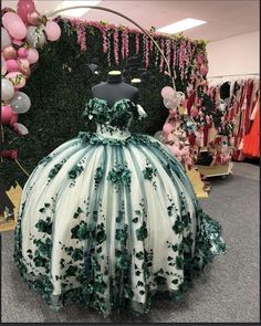 Embrace elegance and grace with this Green Off-the-Shoulder Ball Gown Quinceanera Dress, a masterpiece designed to celebrate your special day in regal style. The enchanting green hue and delicate tulle fabric create a timeless look, while intricate appliqued details and 3D floral embellishments add a whimsical charm. The off-the-shoulder neckline exudes femininity and sophistication, complemented by a fitted corset back that ensures a flawless fit. The dramatic ball gown silhouette cascades into Emerald Quinceanera Dress, Emerald Green Quinceanera Dresses, Green Quince Dress, Green Quinceanera Dresses, Green Ball Gown, Sweet 15 Dresses, Pretty Quinceanera Dresses, Quinceanera Themes, Quince Dress