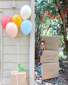 Toy Story's Rex wearing a party hat and holding balloons and Woody Buzz Lightyear and A barrel of monkeys on moving boxes at party entrance Two Story Second Birthday, Simple Toy Story Birthday, Toy Story 1st Birthday Party Ideas Girl, 2 Year Birthday Toy Story, Toy Story Two Year Old Birthday, 3 Year Birthday Toy Story, Third Toy Story Birthday, Third Birthday Disney Theme, Minimalist Toy Story Birthday