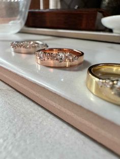 three wedding rings sitting on top of a counter