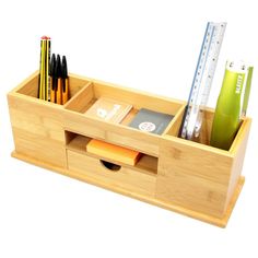 a wooden desk organizer with pencils, rulers and other office supplies in it on a white background