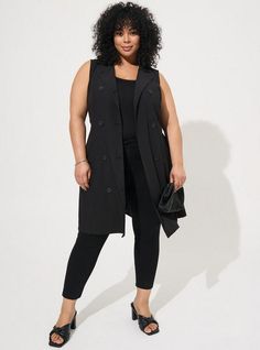 FIT Model is 5'10” wearing size 2. . Measures 44” from shoulder (size 2). Long line silhouette. MATERIALS + CARE Studio Crepe Jersey knit fabric: A refined, textured jersey with the look and drape of crepe but the feel (and stretch! ) of a knit. . Stretch Level: Maximum. . 95% polyester, 5% spandex. . Machine wash cold. Tumble dry low. . Imported. . DETAILS Collared neckline. Sleeveless. The best plus size women's studio crepe jersey lightweight trench vest vests in deep black made of studiocrep Long Black Vest, Fashion 23, Trench Vest, Line Silhouette, Professional Outfits Women, Professional Wardrobe, Hi Low Dresses, Midi Shirt Dress, Virtual Closet