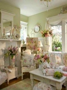 a living room filled with lots of furniture and flowers on the couches in front of a fire place