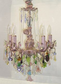 a chandelier hanging from the side of a wall