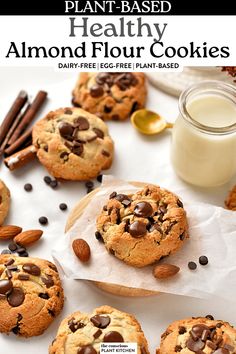 chocolate chip cookies with almonds on parchment paper next to a glass of milk