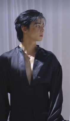 a woman with black hair wearing a black shirt