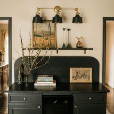 a black table with two lamps on it and some books in front of the top shelf