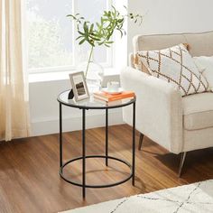 a living room with a couch, chair and coffee table in front of a window