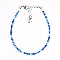 Get ready to shine with this fun and flirty blue and silver seed bead bracelet! The vibrant blue and hint of silver flash are here to add a little pep to your day and sparkle to your style. Lightweight and comfy, it’s perfect for stacking up with your other favorites or rocking solo when you’re feeling bold. Slip it on, and let this dainty little treasure make you feel as fabulous as you look! Materials: size 11/0 glass seed beads beading wire silver plated crimp beads silver plated wire guards Blue Bracelets With Tiny Beads For Friendship, Blue Adjustable Friendship Bracelet With Spacer Beads, Adjustable Blue Friendship Bracelets With Spacer Beads, Adjustable Blue Friendship Bracelet With Spacer Beads, Blue Czech Glass Beaded Bracelets With Round Beads, Blue Crystal Bracelet With Silver Beads, Blue Czech Glass Beaded Bracelets, Blue Beaded Bracelets With Silver Beads, Blue Round Beads Crystal Friendship Bracelet