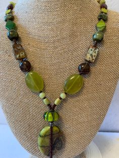 Many shades of green gemstones with green pendant and copper clasp, 26 inches in length. Green Pendant, Brown Gemstone, Green Pendants, Green Gemstones, Green And Brown, Gemstone Necklace, Shades Of Green, Pendant Necklaces, Necklace Etsy