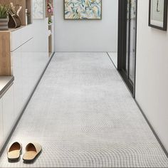 a pair of slippers sitting on the floor in front of a painting and artwork