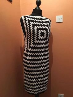 a black and white dress sitting on top of a mannequin