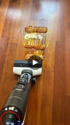 a camera and some food on a wooden floor