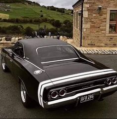 a black and white car parked in front of a house