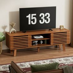 a living room with a large television on top of a wooden entertainment center