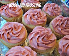 cupcakes with pink frosting sitting on top of each other