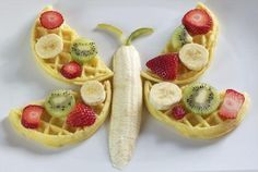 a butterfly made out of waffles with fruit on the top and bananas in the middle