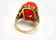 Art Deco Gold Carved Coral Diamond Enamel Ring.This stunning ring is a quintessential representation of the Art Deco era, known for its opulence and distinct aesthetic. At the heart of the ring sits a meticulously carved piece of coral, encased in an elegantly geometric gold setting. 4 diamonds that glisten with every turn, enhancing the ring's allure. Accented by subtle touches of enamel, adding a vibrant contrast to the design. This piece not only showcases the luxury and bold styling characte Luxury Carved Jewelry For Formal Occasions, Carved Diamond Fine Jewelry, Fine Carved Diamond Jewelry, Art Deco Carved Collectible Jewelry, Collectible Art Deco Carved Jewelry, Luxury Carved Rings, Luxury Carved Jewelry For Weddings, Luxury Oval Engraved Carved Ring, Luxury Carved Jewelry For Anniversary