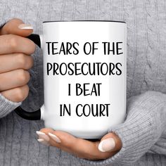 a woman holding a coffee mug with the words tears of the prosecutors i beat in court