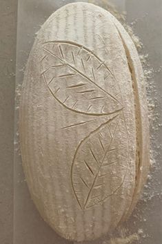 a piece of bread that has been carved into the shape of a leaf on it