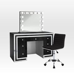 a black and white vanity with lights on the mirror next to a chair in front of it