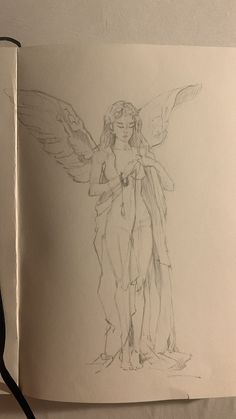 an open book with a drawing of a female angel