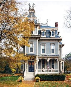 an old victorian style house in the fall