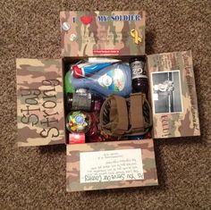 an open cardboard box with items in it on the floor next to a postcard that says, i love my soldier