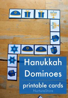 the hanukkah dominoes printable cards are displayed on a wooden table