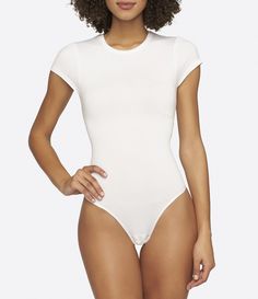 From Yummie by Heather Thomson&#x2C; the Seamlessly Shaped bodysuit features:Outlast fabric that regulates your body temperature by storing heat when you're cold and releasing it when you're hotseamless constructioncrew necklineshort sleevesthong backsnap closure between legsTencel /nylon/spandexmachine washImported. White High Stretch Short Sleeve Bodysuit For Summer, White Stretch Short Sleeve Bodysuit, White Short Sleeve Stretch Bodysuit, Casual Seamless Nylon Bodysuit, High Stretch Nylon Bodysuit In Casual Style, High Stretch Nylon Casual Bodysuit, Stretch Short Sleeve Bodysuit With Crew Neck, Casual High Stretch Nylon Bodysuit, Casual High-stretch Nylon Bodysuit