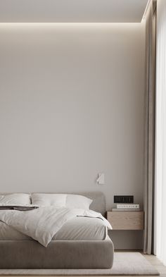 a large bed sitting next to a window in a bedroom