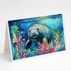 a card with an image of a manatoo swimming in the ocean surrounded by corals