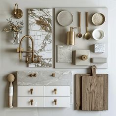 an assortment of kitchen items displayed on a white wall with gold handles and knobs