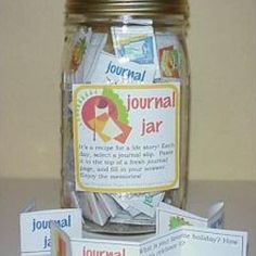 a jar filled with different types of cards and labels on top of a table next to a