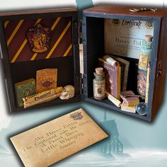 an open harry potter book box with books inside and some writing on the bottom shelf